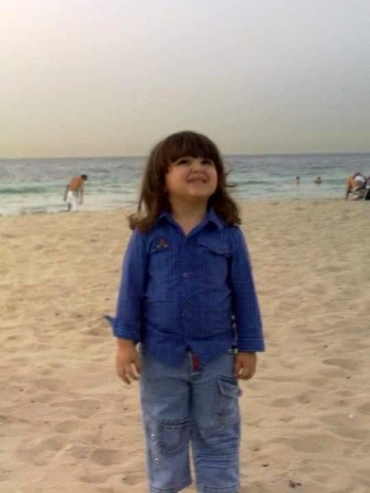 Murtdah Osman as a child on a beach in Dubai